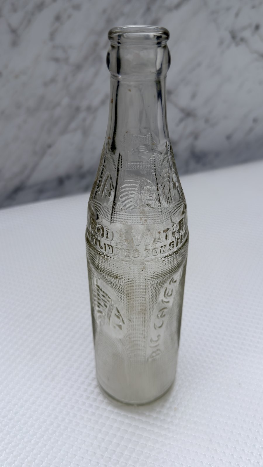 Front of the Big Chief soda bottle with the SODA WATER embossing across the shoulder