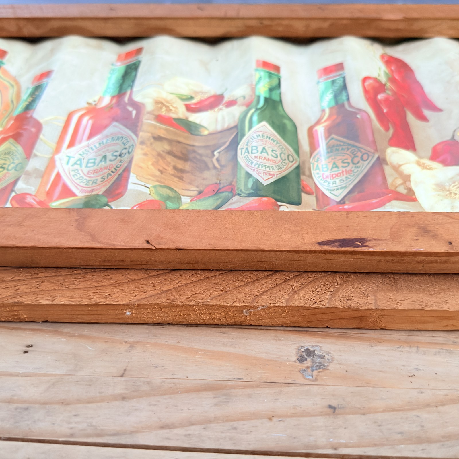 Framed Tabasco Brand corrugated tin Tabasco bottle close-up