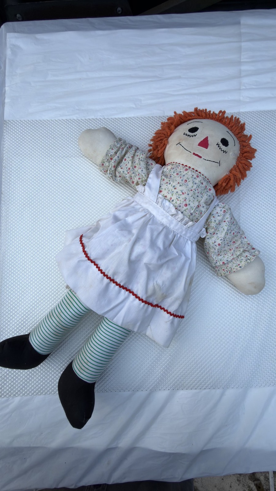 Handmade Raggedy Ann doll full body at an angle, showing the thick mop of orange yarn hair