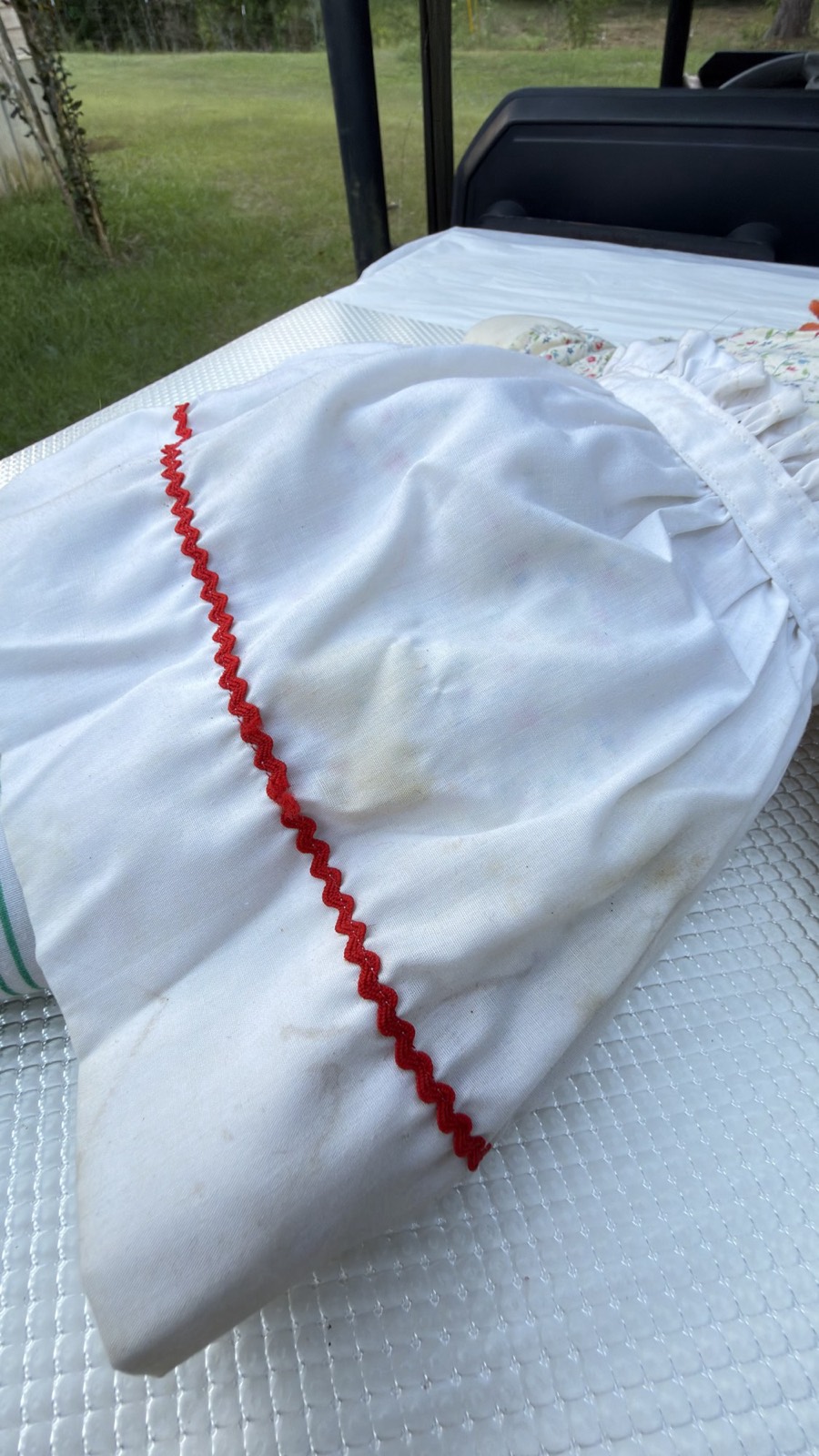 Second angle of the staining and yellowed spots on the Raggedy Ann's white apron