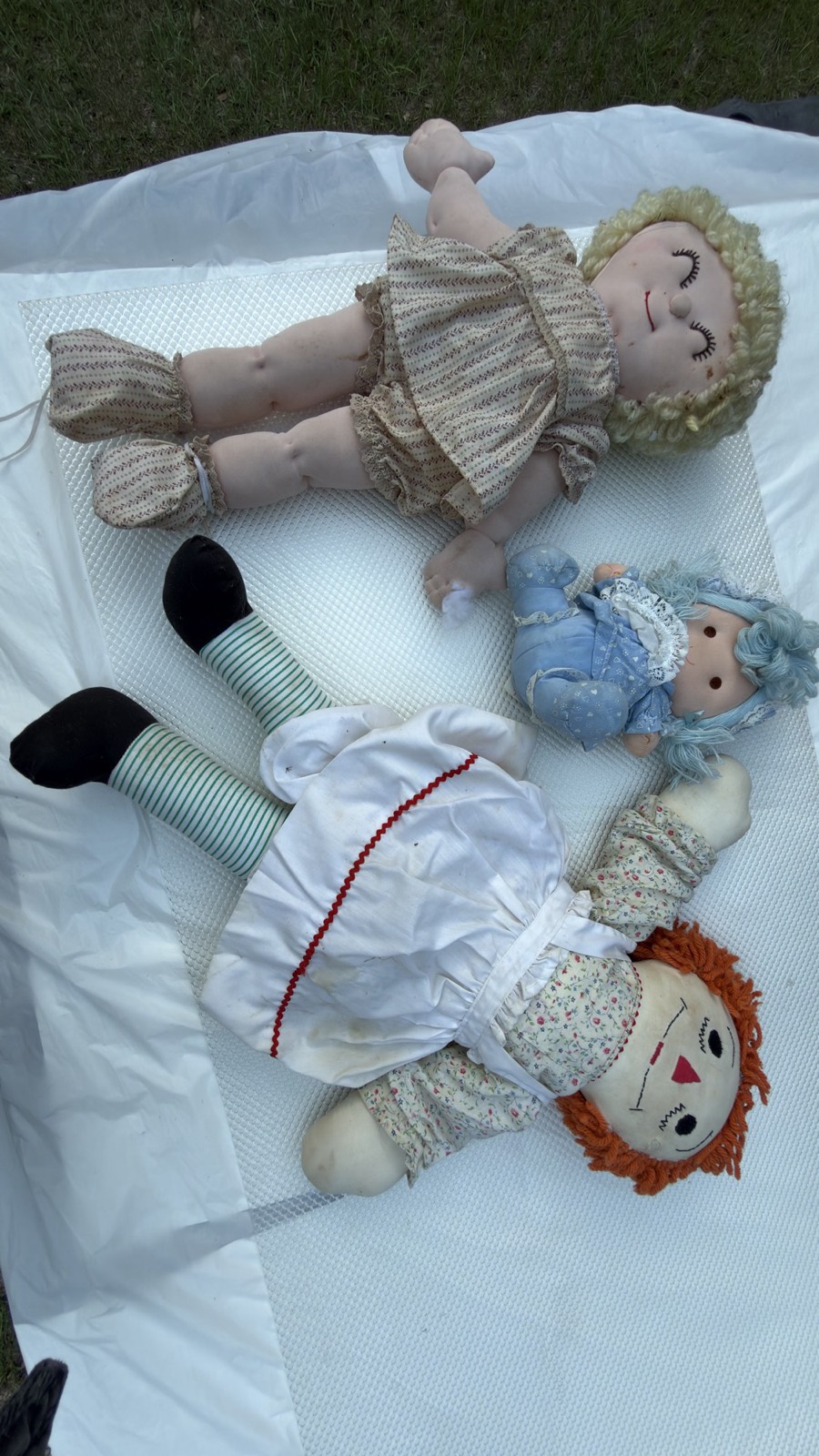 The large handmade Raggedy Ann photographed alongside the other vintage dolls in the group