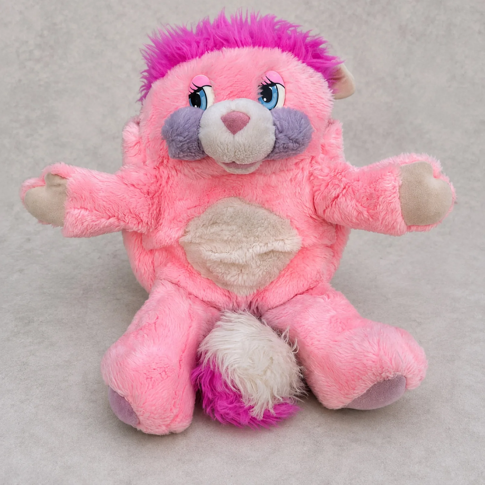 Vintage 1985 Party Popple seated upright, full front view — pink plush, magenta hair, lavender-grey muzzle and cream pom tail