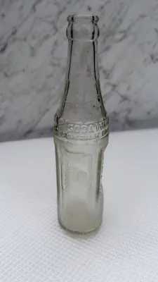 Embossed Indian chief head in full headdress on the body panel of the bottle