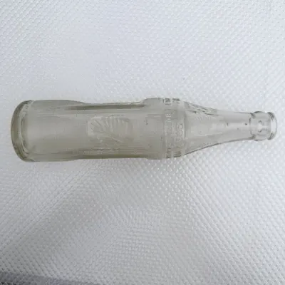 The Big Chief bottle laid on its side showing the chief head panel in raking light