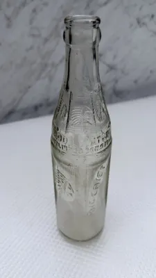 Front of the Big Chief soda bottle with the SODA WATER embossing across the shoulder
