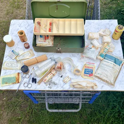 Wider view of the mixed medical contents spread out beside the case