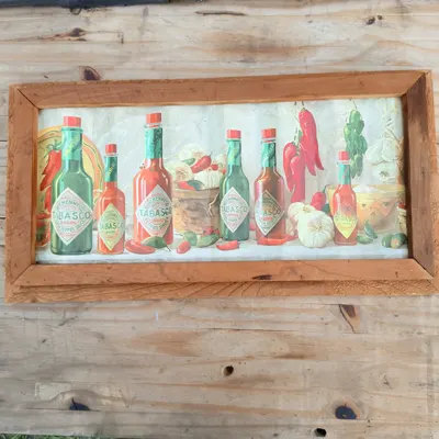 Framed Tabasco Brand corrugated tin bottle detail