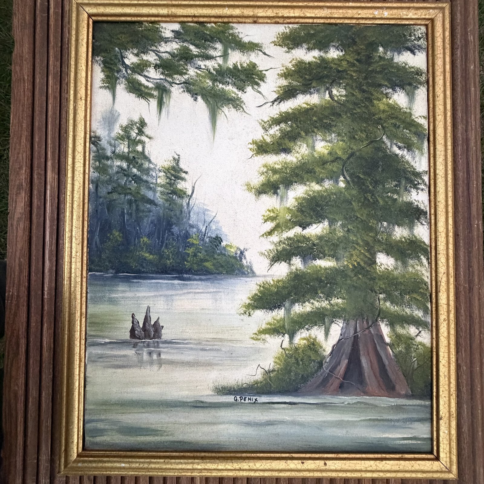 Full view of the framed swamp painting showing the gold frame and its aged finish