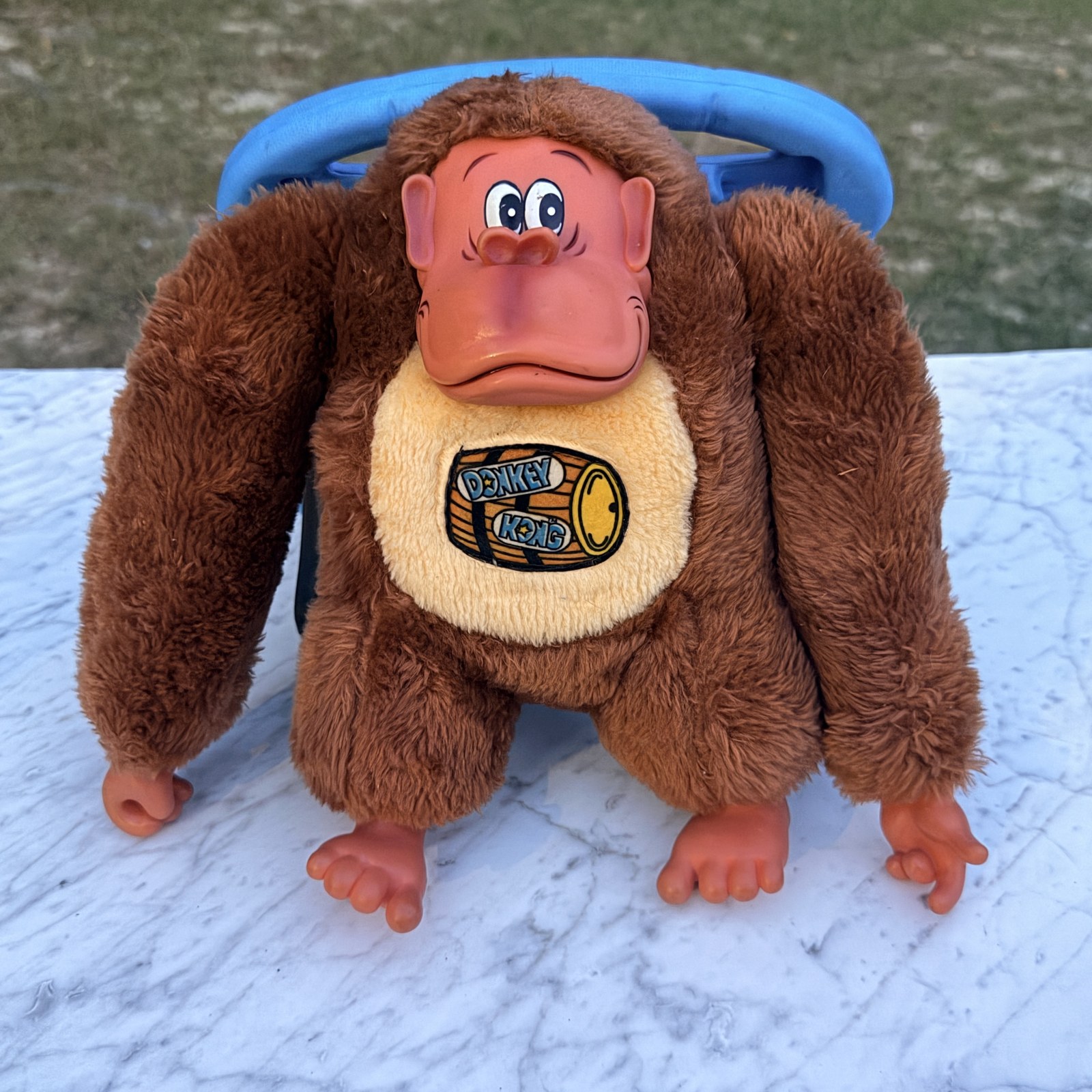 Donkey Kong plush seated upright with an 11-inch iPad standing behind it for scale