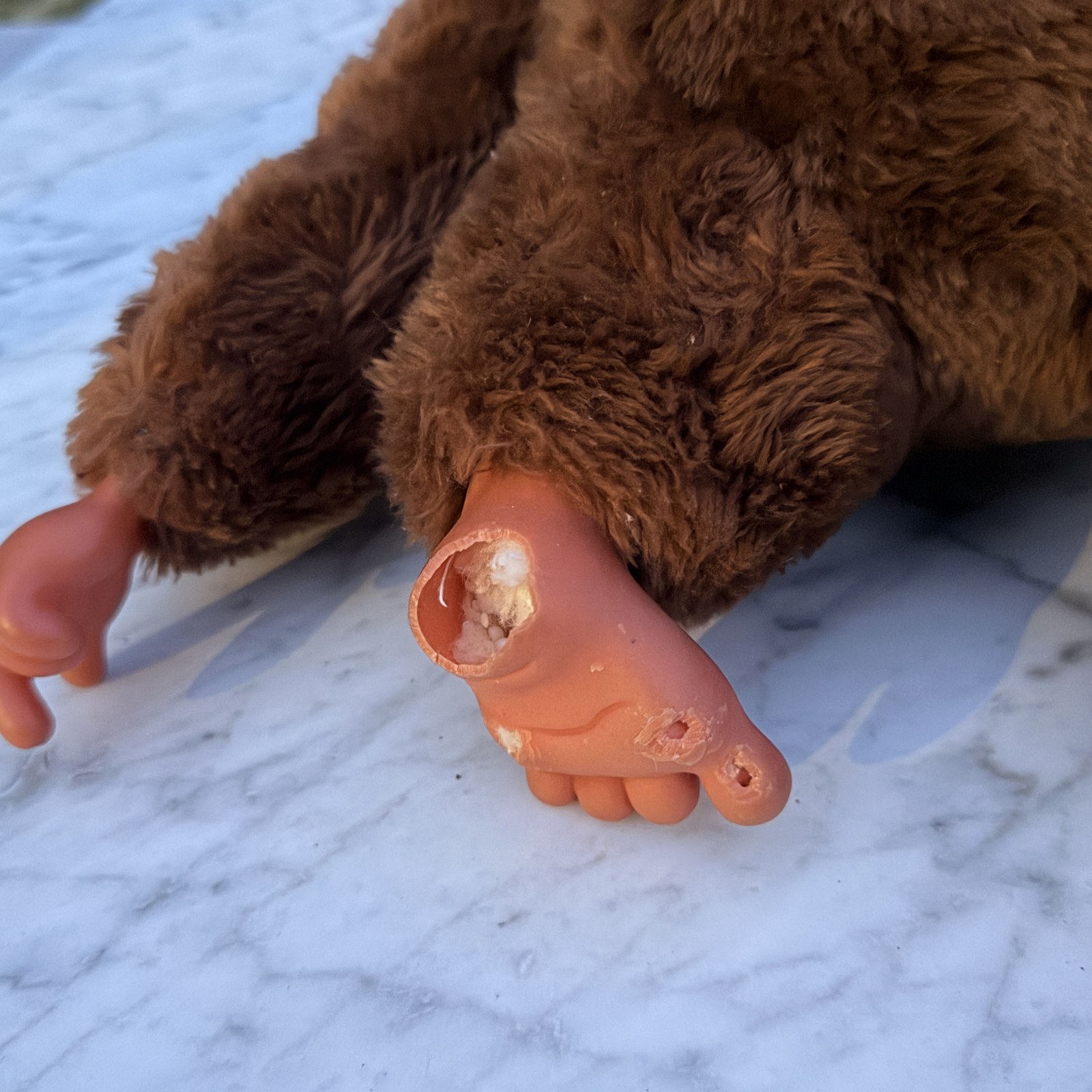 Close-up of the second molded foot: hole through the top near the ankle and two smaller cracked spots near the toes