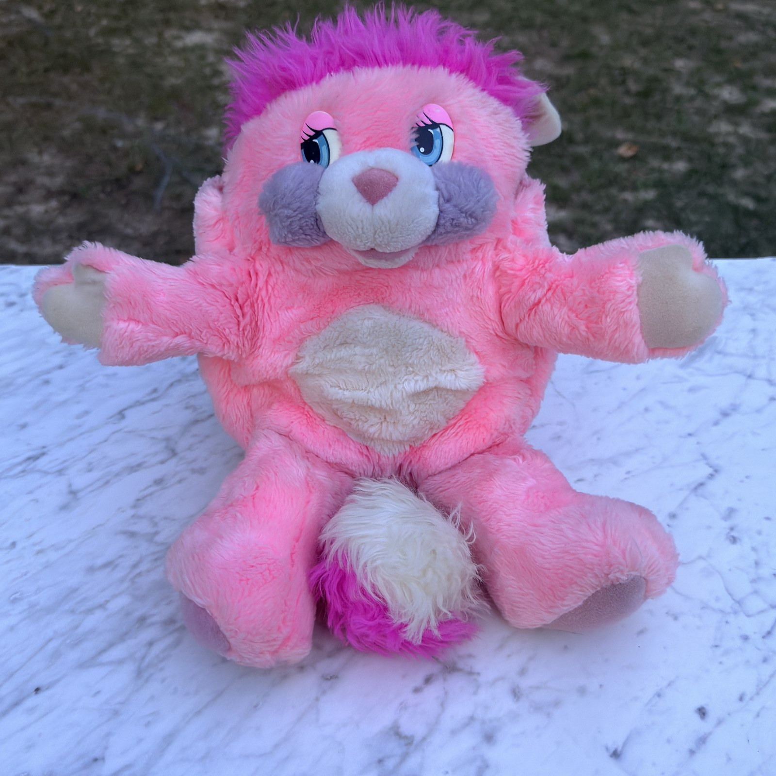 Vintage 1985 Party Popple seated upright, full front view — pink plush, magenta hair, lavender-grey muzzle and cream pom tail
