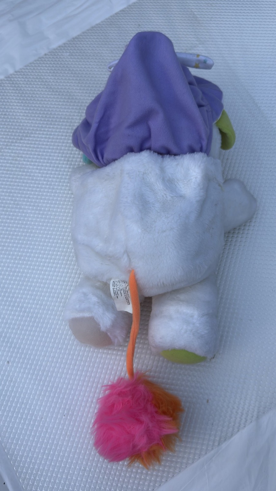 Back of the Baby Cribsy Popple showing the intact purple hood pouch and pom rattle tail