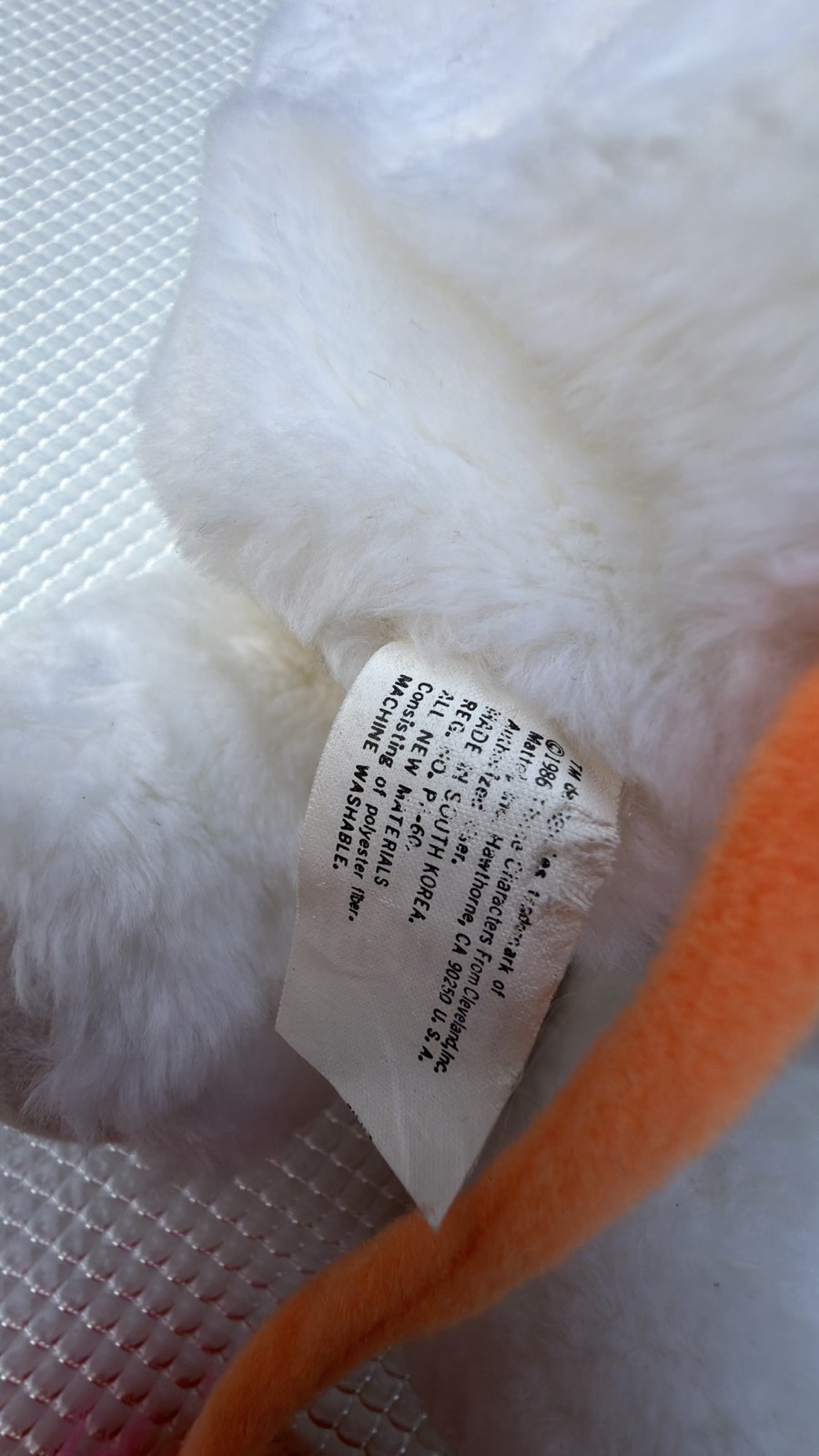 Close-up of the original 1986 Mattel manufacturer's tag, still attached and readable