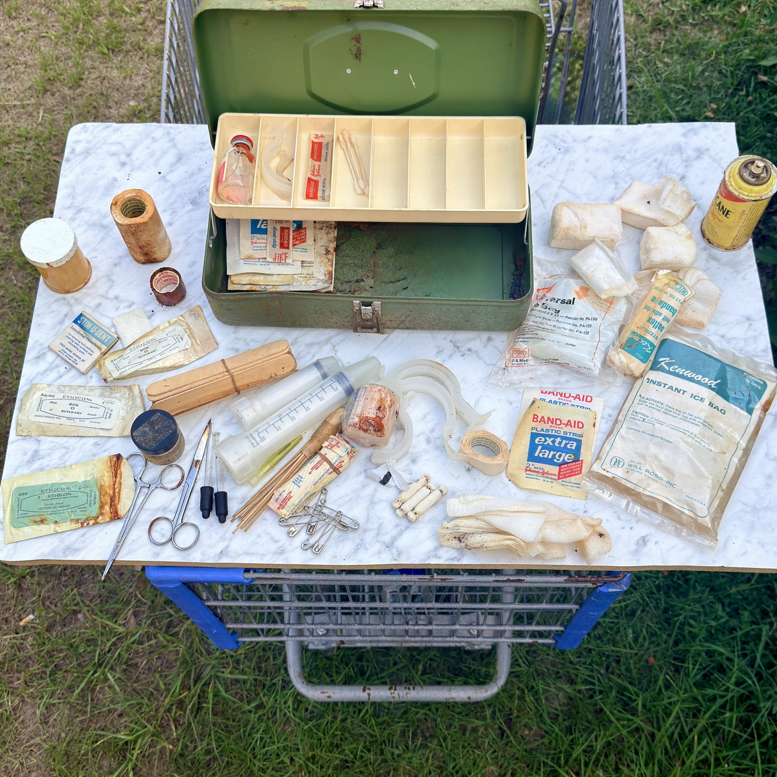 Wider view of the mixed medical contents spread out beside the case
